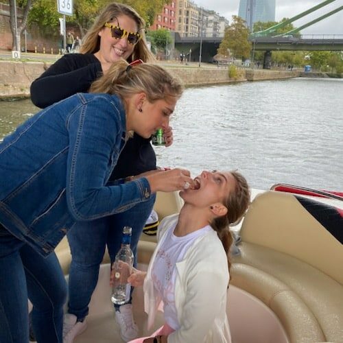 Frauen beim Trinkspiel zum anheizen einer Party auf einem Boot